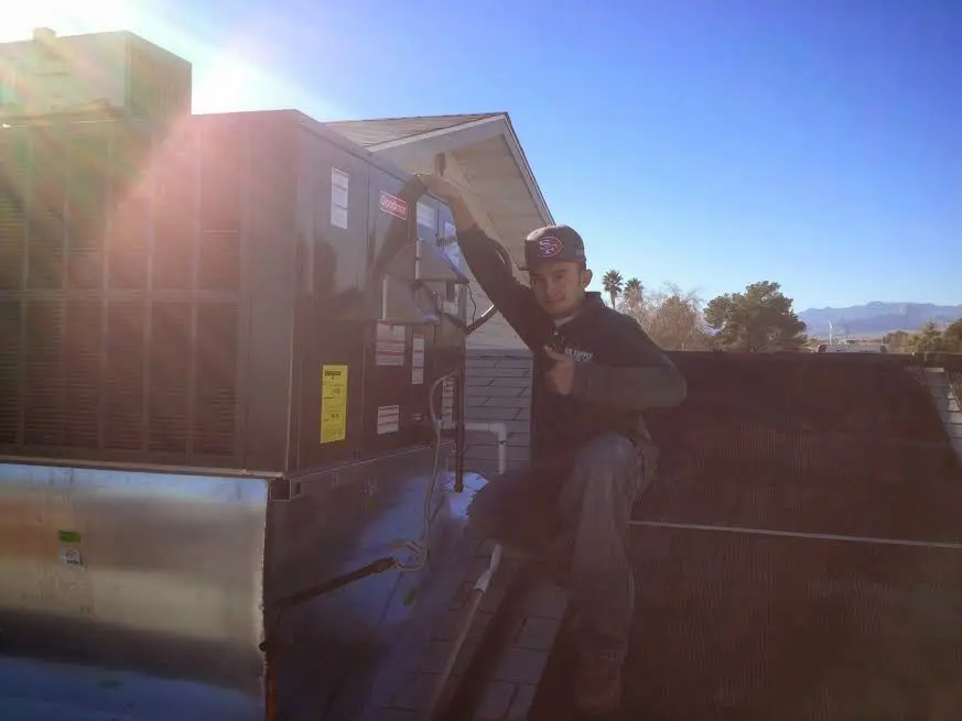 HVAC technician performing Heat Pump Repair on a rooftop unit in Coral Terrace